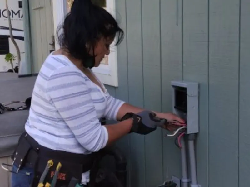 Licensed electrician wiring an exterior subpanel in Fort Mohave